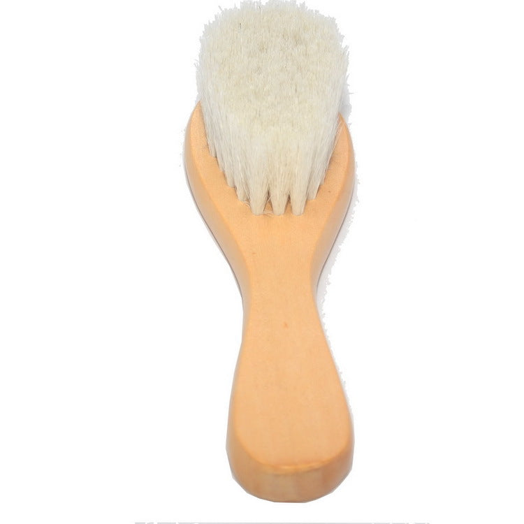 A wooden hairbrush with soft, dense white bristles, set against a white background. The handle tapers slightly toward the top, providing a comfortable grip.