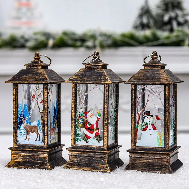 Three decorative lanterns with bronze frames display festive winter scenes: a deer in a snowy forest, Santa with a gift bag, and a cheerful snowman with a green scarf.