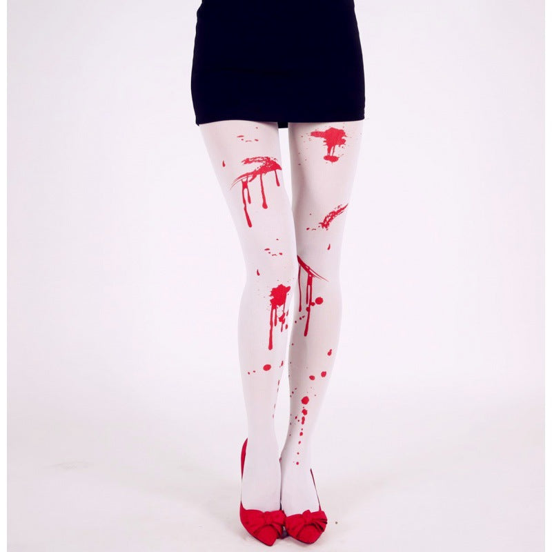 White tights with red paint splatters, resembling blood, paired with red shoes featuring bows, and a black skirt, creating a bold fashion statement against a plain background.