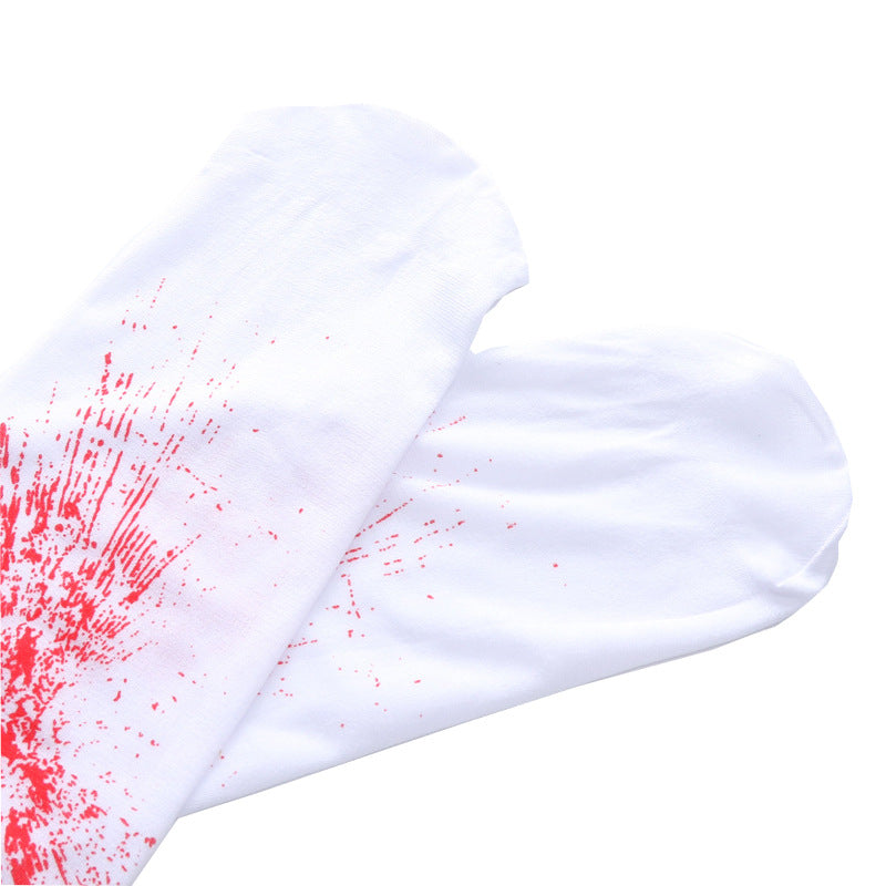 A pair of white socks with a red splash pattern on the fabric, creating a dynamic and artistic design.