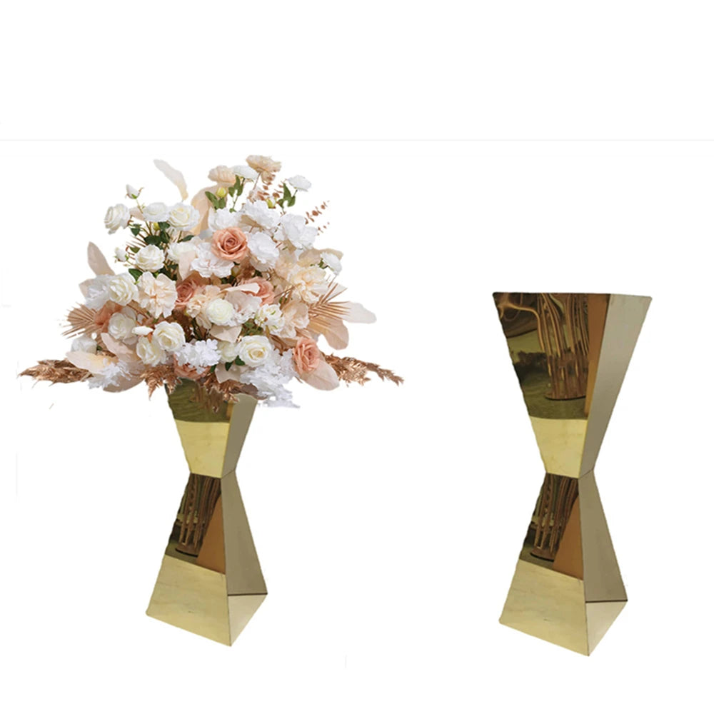 Gold geometric vase with a bouquet of white and peach roses, displayed alongside an identical empty vase. The arrangement highlights contrasting textures and colors.