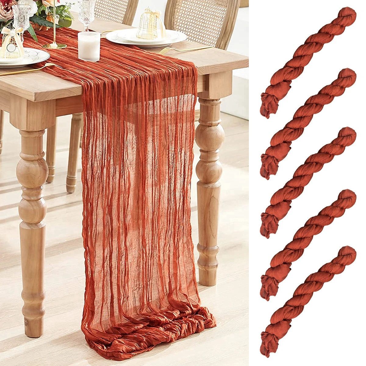 Rustic orange gauze table runner draped over a wooden table with elegant dining setup. Five matching twisted bundles of fabric shown on the right side.
