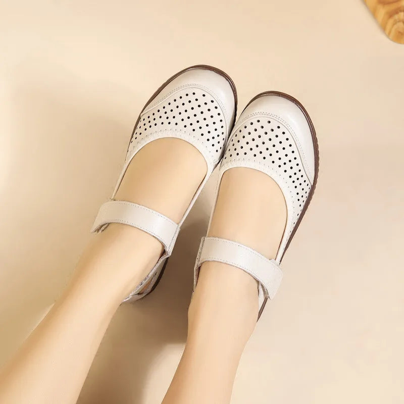 Beige Mary Jane shoes with perforated pattern and adjustable straps are worn, showcasing a casual yet stylish design.