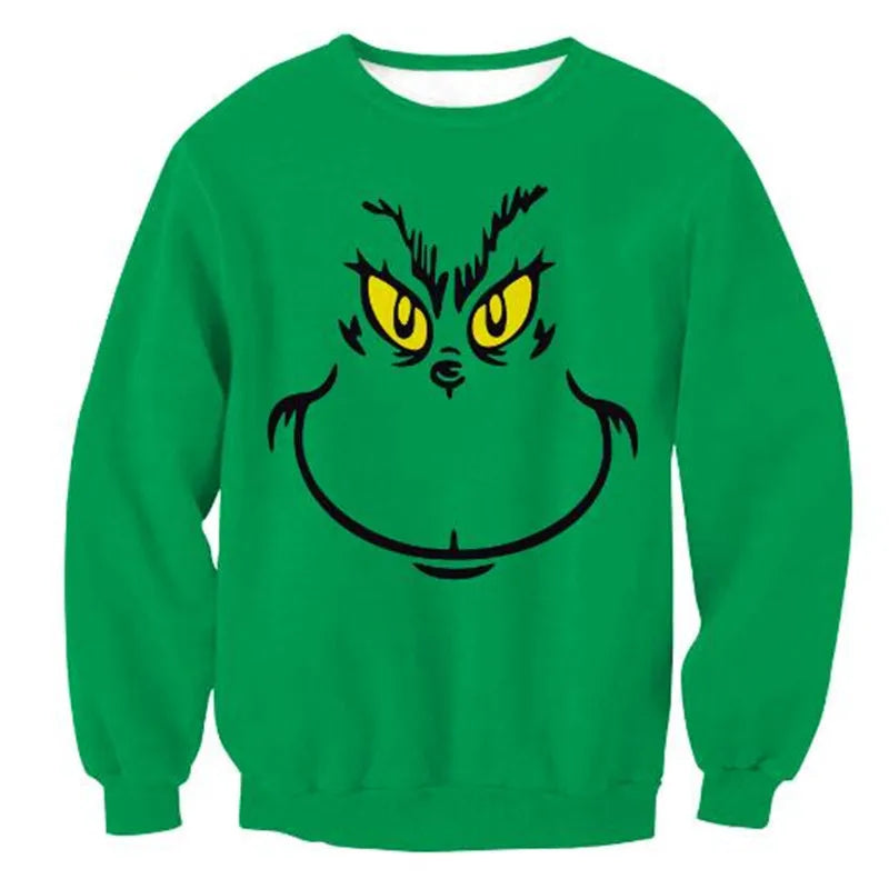 Green sweatshirt featuring a cartoon face with yellow eyes and a mischievous grin, set centrally on the front.